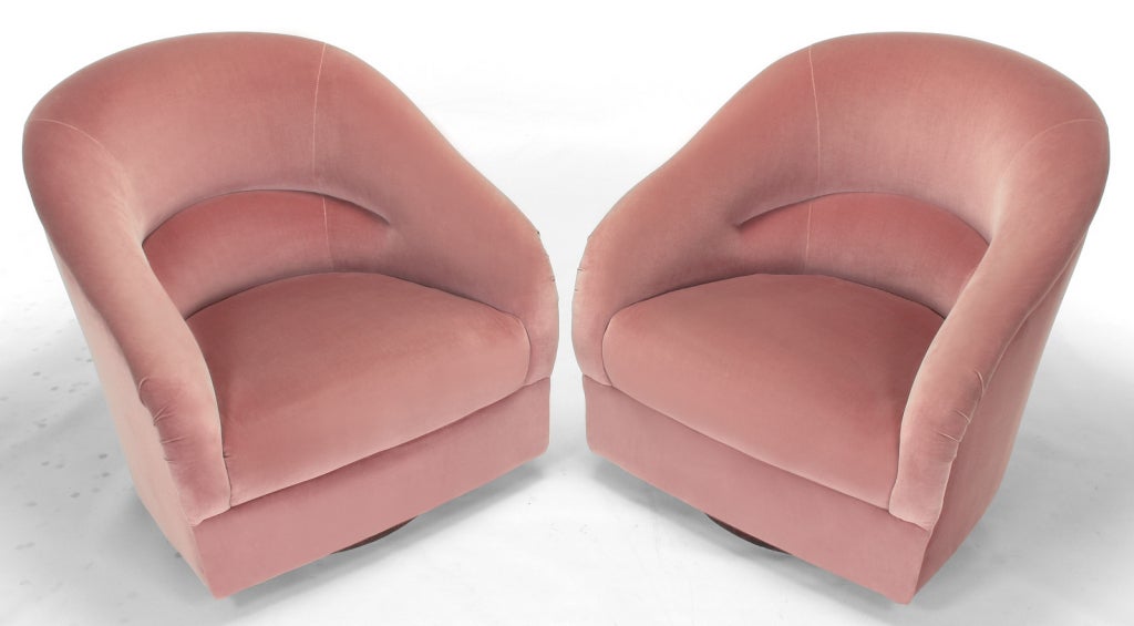 Sleek and sculptural pair of rarely offered Ward Bennett barrel back swivel chairs. Covered in the original blush pink velvet upholstery that is in very good condition.