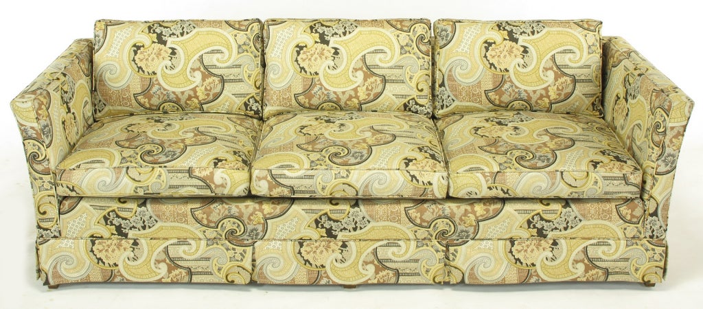 Extremely comfortable, three seat sofa with down-filled seat cushions by Baker Furniture. Upholstered in a vivid Asian print, the cotton fabric incorporates traditional Japanese patterns, paisleys, chrysanthemums, orchids, and magnolia blossoms,