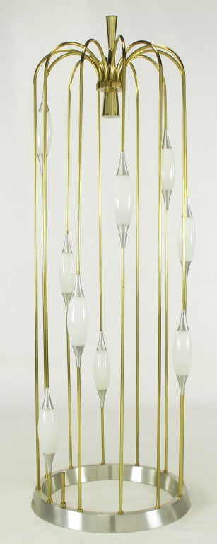 Pair of incomparable ten light Lightolier floor lamps. Brass tubes that cascade from a center hour glass shaped finial, disc and conical down light. Nine milk glass shades are held in place by brushed aluminum trumpeted fitters. Brushed aluminum