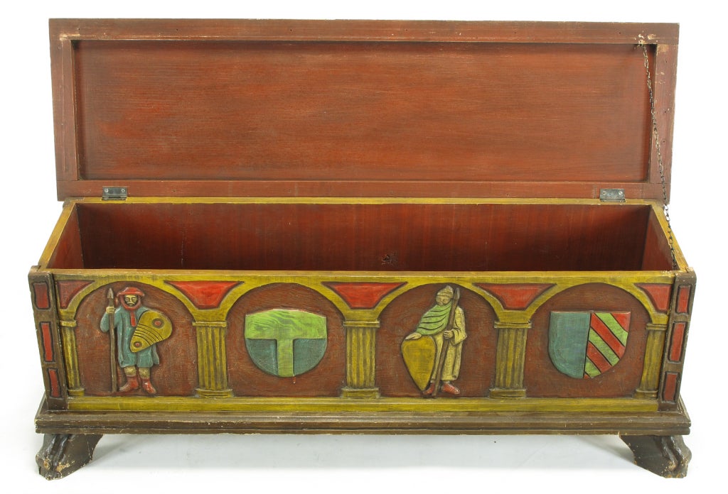 Artes de Mexico hand painted blanket chest or trunk. Spanish Revival themes of familial crests and warriors are carved into the wood front, back and sides and hand painted. Top has a carved and hand painted border with a scarlet center as well as a