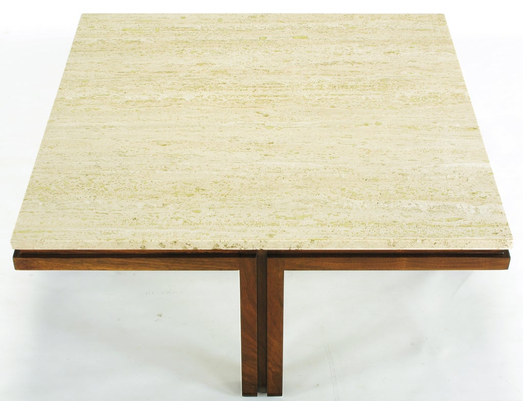 Walnut wood and travertine top coffee table with legs centered on the sides. Each leg comprised of the union of a pair of wood verticals with open center and top reveal, then placed in the center of each side of the square. Uncommon design that from