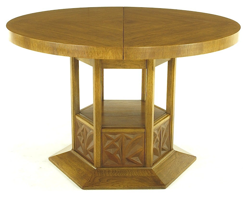 Sculpted ashwood dining table with open hexagonal pedestal base with cast and inset resin panels by Kroehler. Beautifully grained parquetry top with a single leaf.