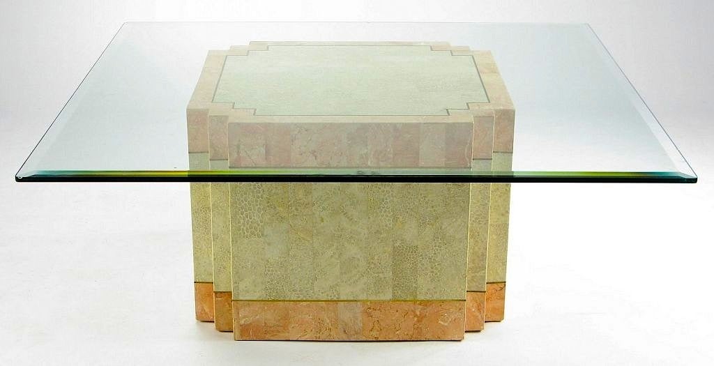 A derivation of Art Deco style, this coffee table has a square base with setback corners. The strong geometric form is accentuated by the coral color marble and fossil stone cladding, separated by solid bands of brass. Designed by Marcius for Casa