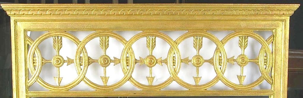 A fine and well executed example of Italian Empire design. Open transom featuring interlocking circles and crossed arrows. The frame is carved wood and finished in patinated gilding. Possibly a Fratelli Paoletti of Firenze design.