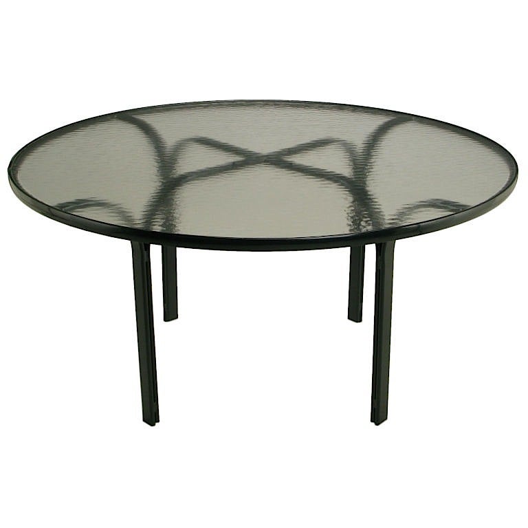 From the singular collection Jay Spectre designed for Brown Jordan, this table is lacquered in dark blue with the original translucent glass top. Very much in the Art Deco revival style that was Spectre's metier, this table can be used outdoors, or