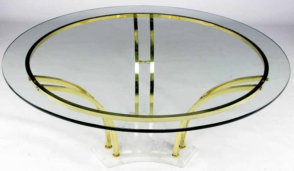 Beautifully constructed carrera marble and brass bar coffee table that has been recently restored to original quality. The curved brass bars, the hourglass stretchers, and the brass bar ring combine to make a striking and architecturally appealing
