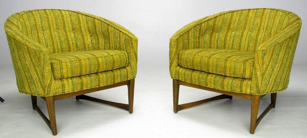 Excellent pair of barrel back club chairs in the original loosely woven striped green & gold blended wool fabric. The oak base, with canoe-paddle stretchers, adds a pleasing architectural aspect to these exquisite chairs. Designed by Lawrence