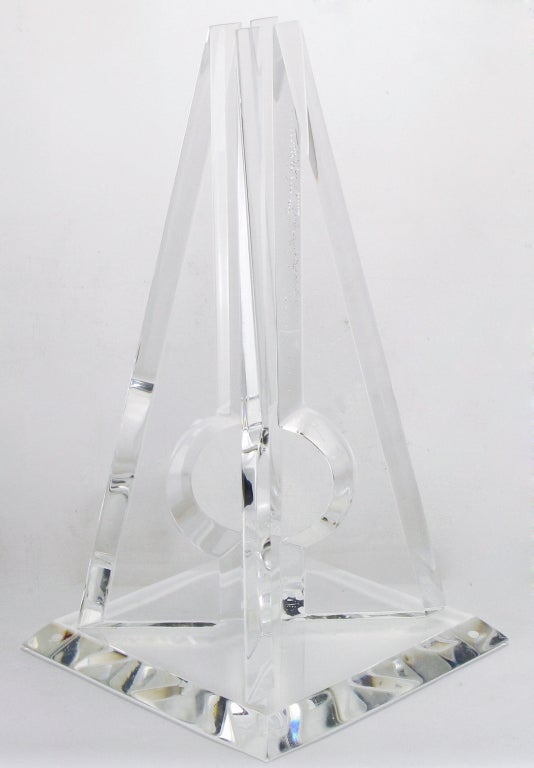 Four part acrylic pyramidal sculpture by Hivo Van Teal. Four canted and bevelled triangular pieces of acrylic or Lucite with an open circular carved centre. All surmounted on a bevelled plinth base. Signed, lower right corner.