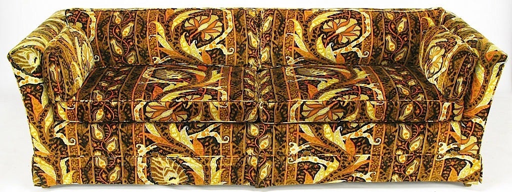 Angled and even arm sofa with loose, tethered cushions by Drexel Heritage. Upholstered in the original vivid abstract floral patterned black, orange, tan and gray, in the manner of Jack Lenor Larsen cotton/silk velvet fabrics of the time. Sized