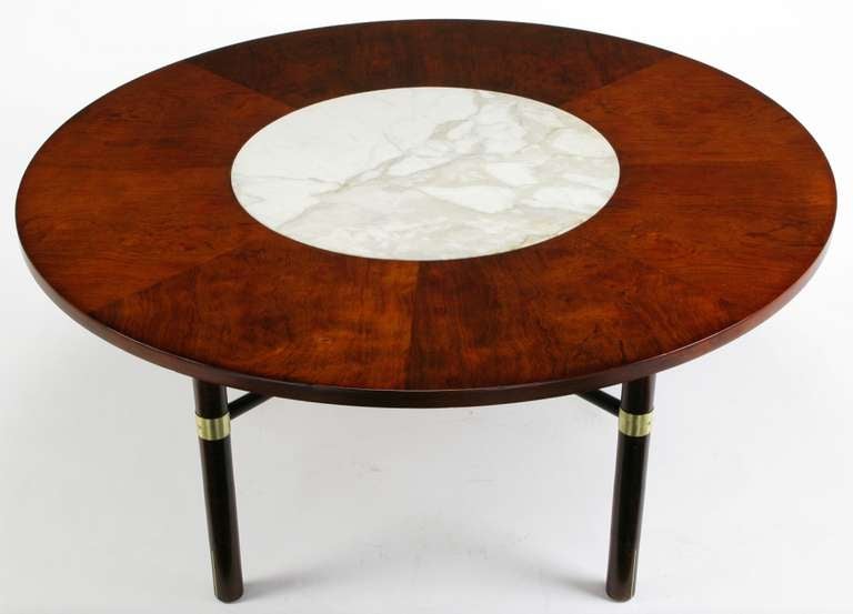 Harvey Probber round figured walnut and white Carrera marble top inset game table with large dowel style brass inlaid legs, brass banding and x stretcher base. At 24.5