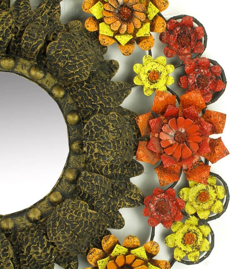 Fantastically uncommon flower encircled mirror of lacquered tole metal and gesso. Open frame work with depth and relief floral detail. 

Artes De Mexico was a San Miguel de Allende atelier where dozens of artisans created furniture in styles