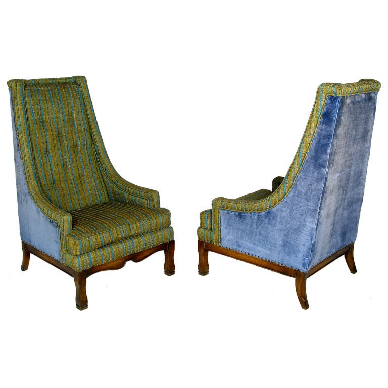 Pair of classic tall back arm chairs with a twist. These chairs by Fort Worth furniture maker, Brandt, feature a wonderful original raw silk blend buttoned back, seat and inner arms. The back and sides are a beautifully contrasted blue velvet. The