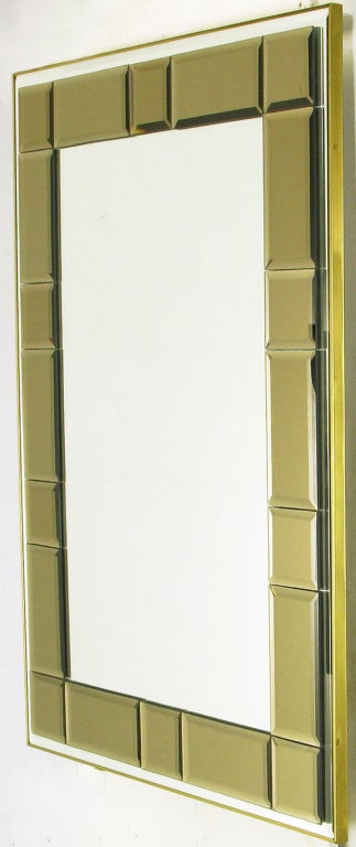 Striking and distinctive, this LaBarge mirror is clad in a simple brass frame, with the beveled mirror surrounded by a beveled and smoked mirrored mosaic border. It can be hung vertically or horizontally.