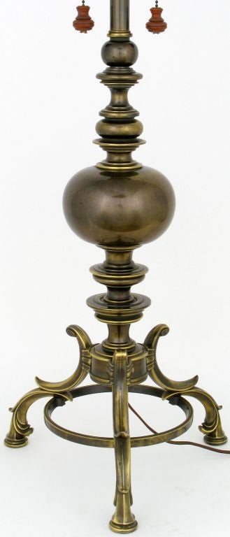 Brass neoclassical dual socket table lamp by Stiffel. The base is an antiqued solid brass tripod with Italianate legs and a segmented baluster. The switch pulls chains end in a unique turned wood finial. Quite impressive in size and form. Most