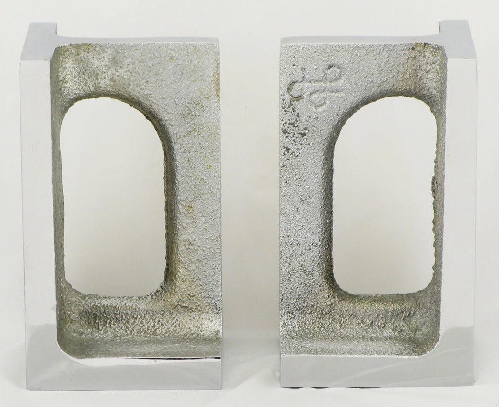 Pair of studio designed and cast aluminum bookends with polished edges and brutal influences. Signed by the artist.
