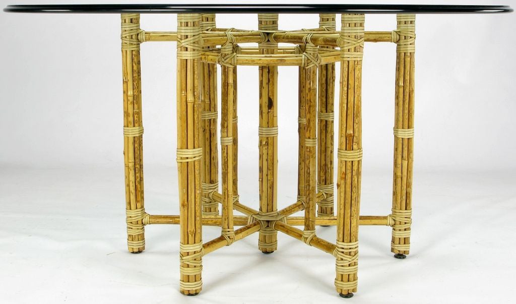 Very well made bamboo table base from organic furniture manufacturer, McGuire. The reeded bammboo is wrapped with raw hide strapping and covers a welded iron bar subframe. This table comes with a 54