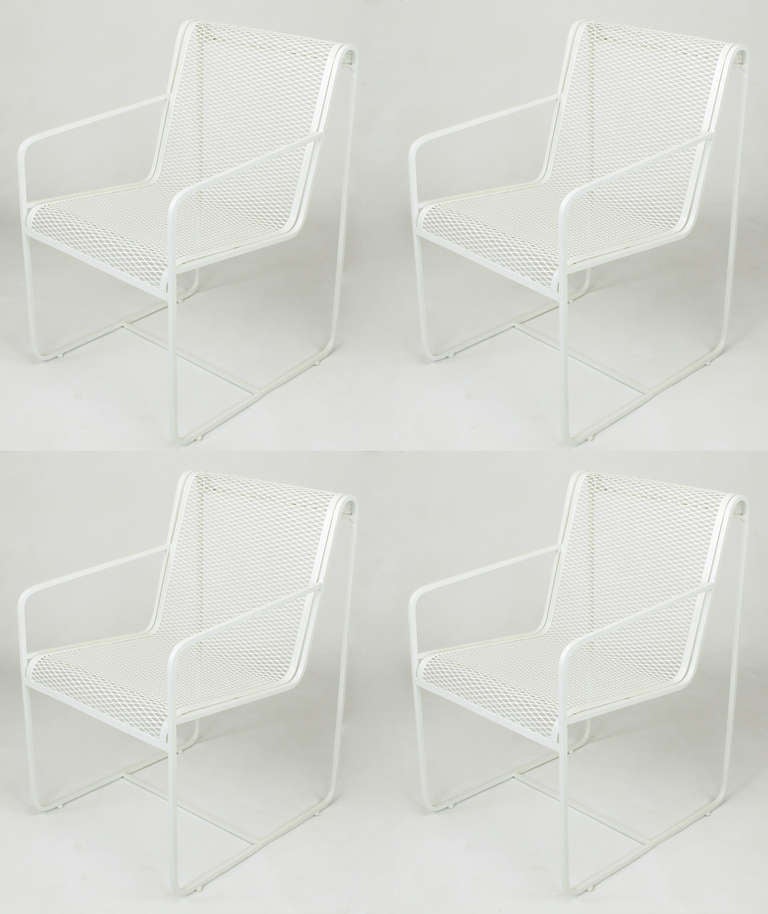 Rare Set of four Maurizio Tempestini for Salterini white lacquer over wrought iron outdoor dining chairs. Minimalist design with open arms and linear form, iron mesh seat and back flow seamlessly.

For best price and shipping options, please