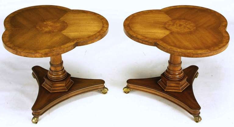 Pair of Regency side/end tables with burled walnut trefoil parquetry tops. Nicely carved solid walnut pedestals on a reverse trefoil base with covered casters. Excellent build quality by Weiman, when it was still located in Rockford, IL, on par with