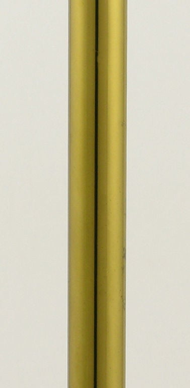 Brass stemmed and tulip shade torchiere with four arched legs.