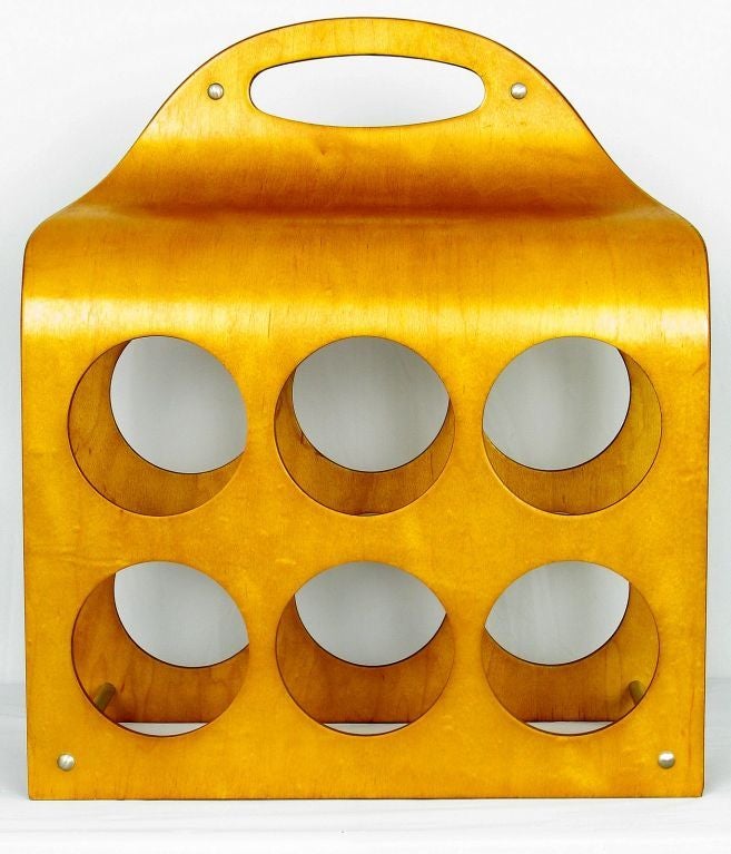 Multiple plies of bent birch wood form wine bottle caddy designed with travel in mind. The top carved oval handle enables easy carrying.