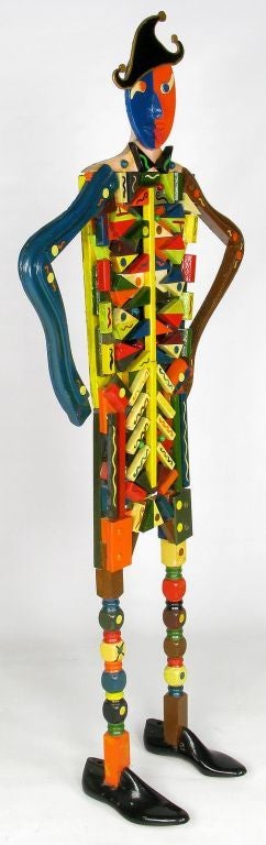 Nearly six feet tall, this one-of-a-kind sculpture is created from carved wood and vibrant multi colored lacquer. Bright reds, blues, greens, yellow, orange and black. Signed 