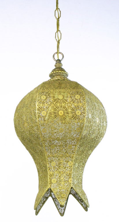 Lacquered and pierced pendant light in the form of an inverted rose bud. Six reticulated panels cast a pattern on the walls and ceiling when illuminated. Four socket internal cluster with turn switch to light 2 or four incandescent bulbs.