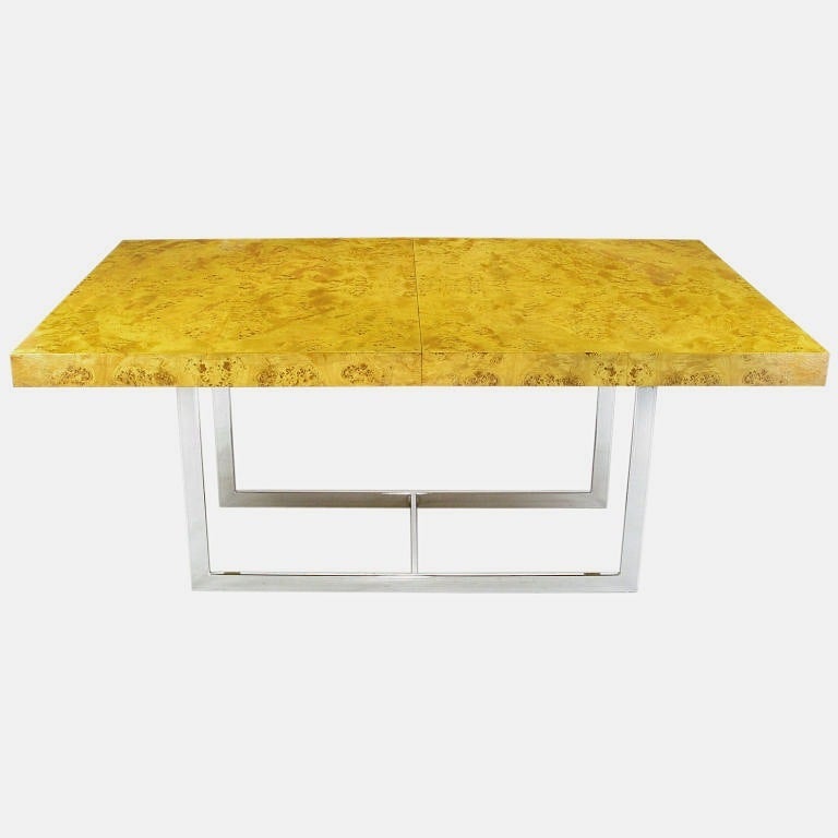 Napa burled wood and chrome dining table in the manner of Milo Baughman. Excellent burled mapa wood veneer with depth and vibrancy. Chromed flat bar steel double U shaped base with center low stretcher.  When combined with the two 17.5