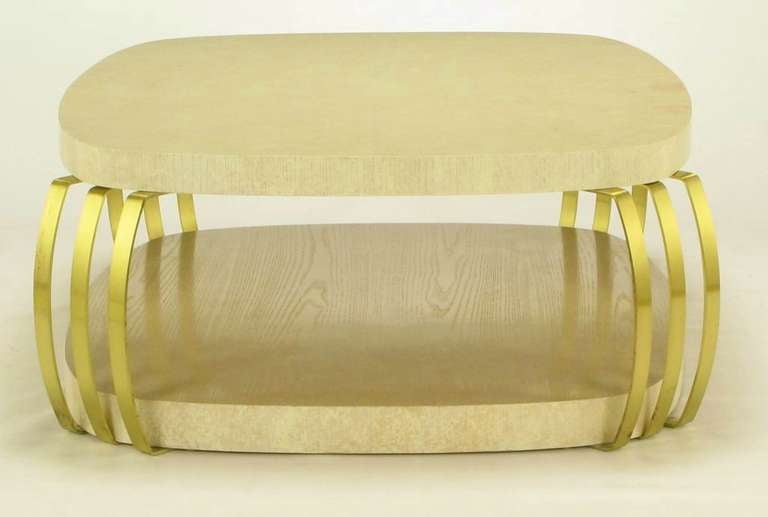 Oak and brass banded post modern coffee by Henredon. Squared shape with rounded corners and curved edges, this double surfaced coffee table is substantial in size, weight and design.<br />
<br />
