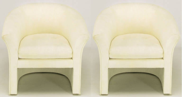 Pair of elegant deco revival club chairs by Hekman Furniture's Dansen Contemporary division. Outward curve of the arms, and sloping shoulders, are updates to 1930s Art Deco period designs. Upholstered in off-white silk with an understated