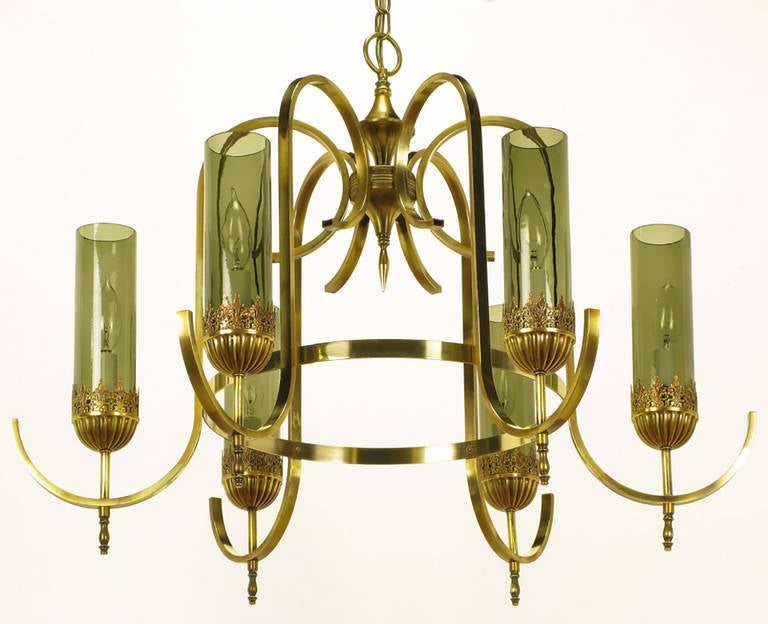 Gracefully swooping flat bar arms start at the centre geometric pendant and finish at the brass ring. Each light is connected to the centre of a perfectly curved half circle arm by a slim rod and lower finial. Fluted and filigreed bobeches house the