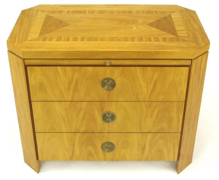 Pair of beautifully grained primavera mahogany night stands with flush concentric circled brass pulls. Canted corners with recessed sides and parquetry top. Two drawers, one  with double depth, one single depth and a pull out shelf surface,  See our