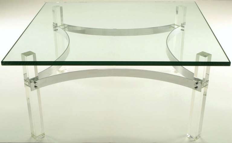 Glass topped coffee table with four canted Lucite legs. Bent and chromed thick metal bands connect each leg forming a diamond shape center. Cylindrical chrome fasteners attach the bands to the legs. In the style of Charles Hollis Jones. Glass top is