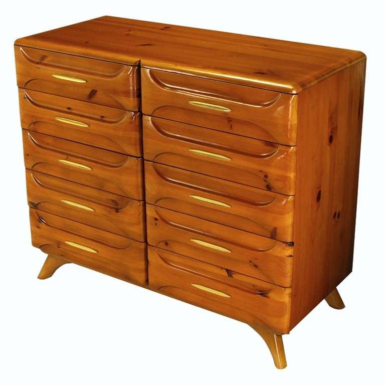 Beautifully grained heart pine ten drawer chest, or dresser, with brass drawer appointments. From the Sculptured Pine line by Franklin Shockey Company of Lexington NC. Curved legs and radiused edges. Drawers are accessed by carved panels that