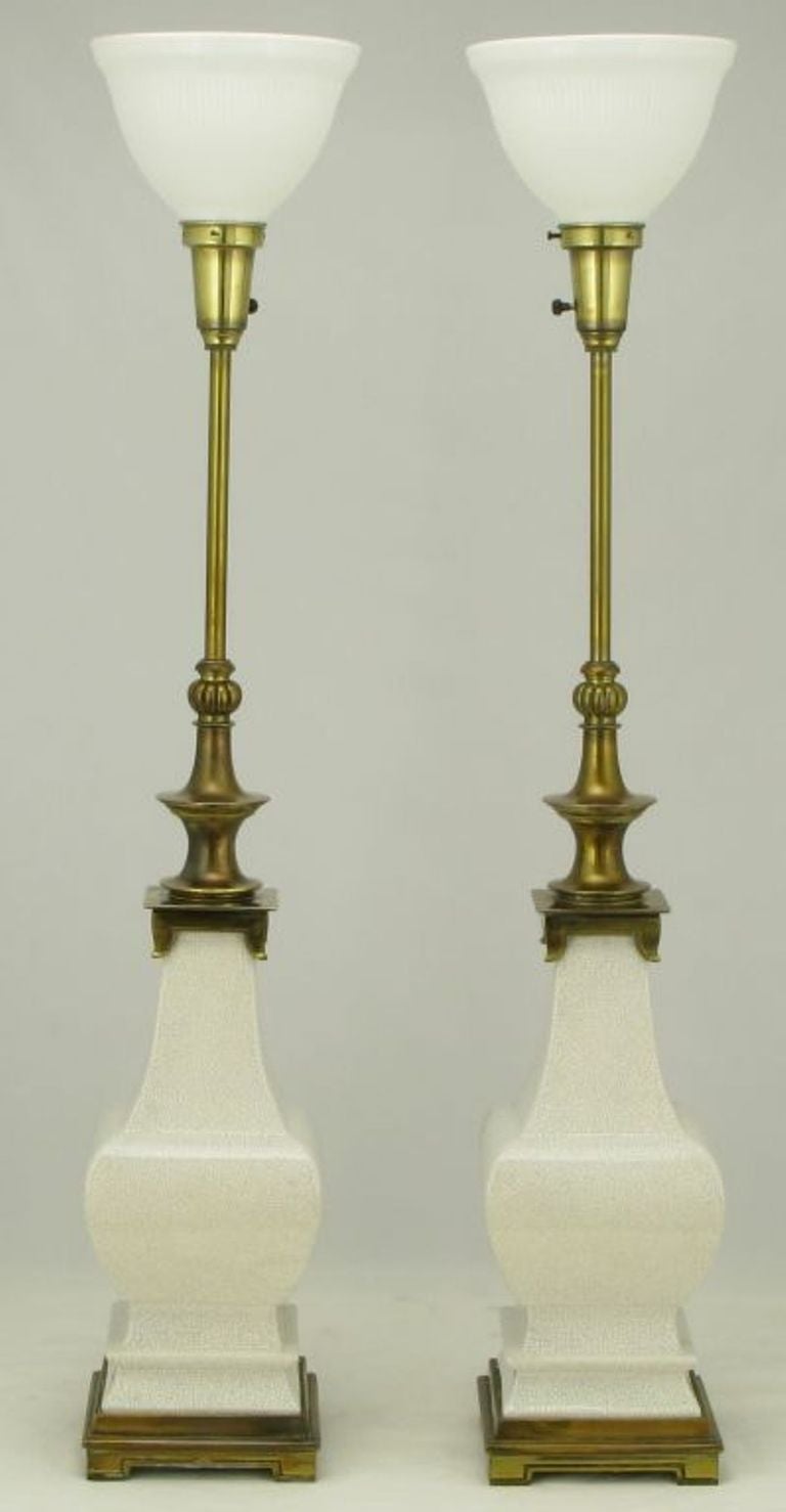 Pair of heavy bodied, white craquelure glazed ceramic table lamps. Patinated brass appointments from the best days of American premier lighting company, Stiffel. Sold sans shades.