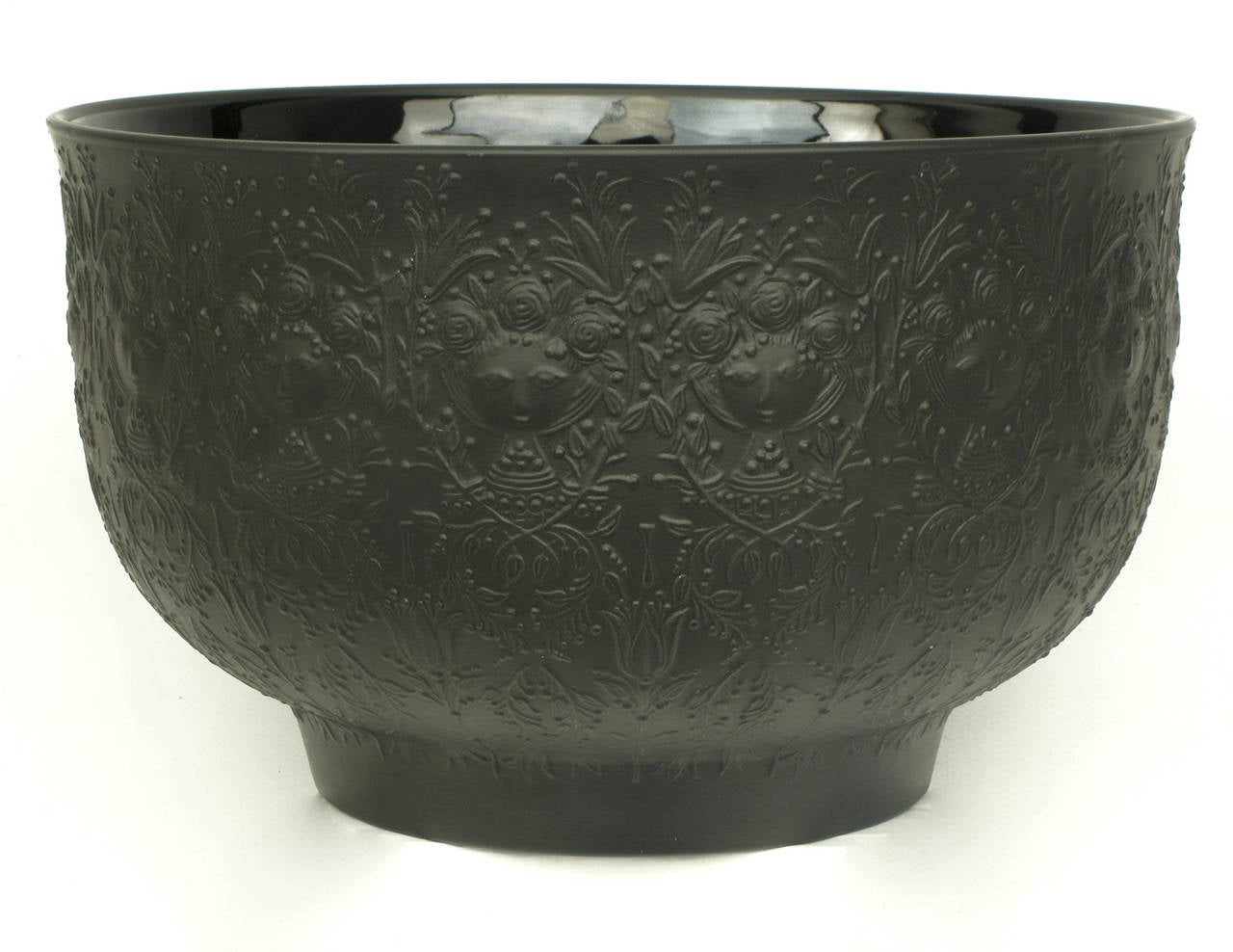 Black porcelain serving bowl by Bjorn Wiinblad for Rosenthal's Studio Linie. Encompassed by Wiinblad's whimsical female character and psychedelic Victorian vines and flowers.