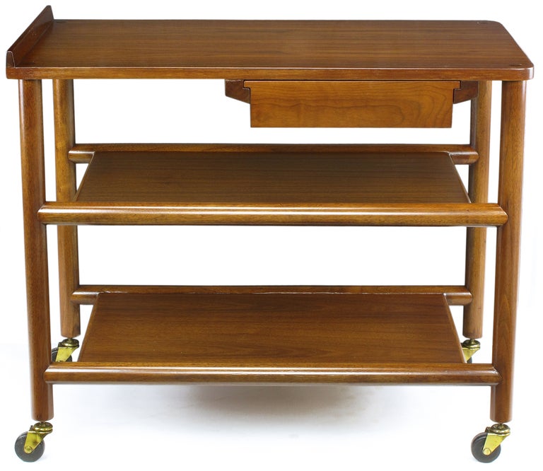 William Pahlmann walnut cart with single two-sided drawer. Restored completely with exception of the rubber and brass casters. Could be used as a serving cart, bar cart, or office cart.