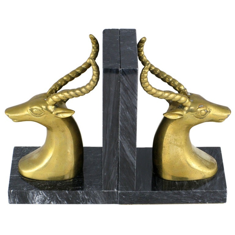 Exquisite pair of art deco revival gazelle mount bookends in brass and black marble.