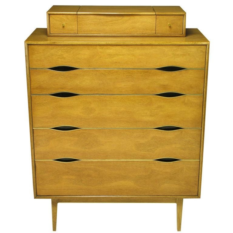 Tall five-drawer commode from Vignola Furniture, Chicago, Il. Bleached walnut case and drawer fronts, brass edging and black lacquered 
