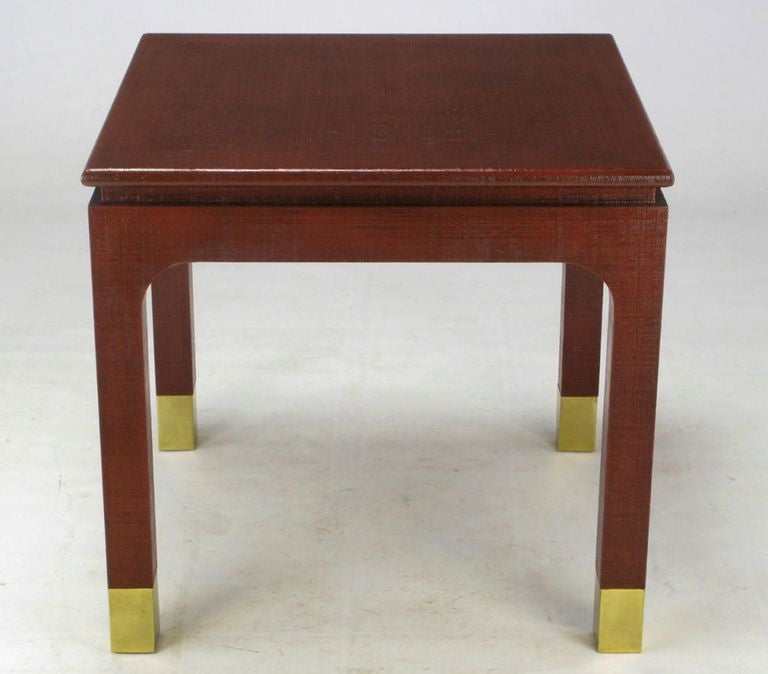 Harris-Van Horn lacquered linen game table  with incised apron and large brass sabots. Could also function as an end table or corner table between a two part sectional sofa. 
