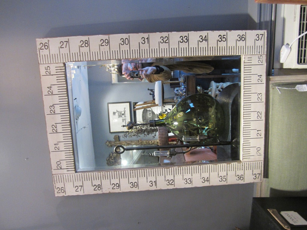 Painted wood surveyor's rule framed mirror with beveled glass.