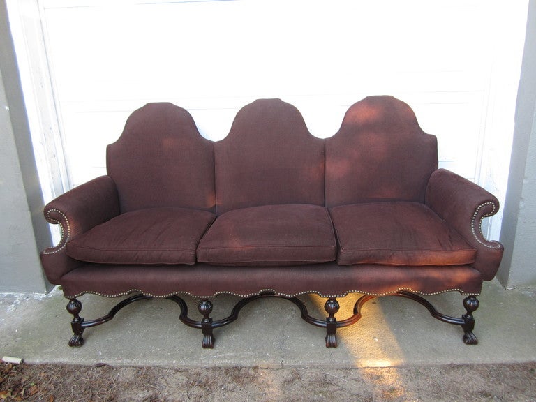 Great hall sofa or settee in the os du mouton style beautifully done up in a raisin-colored corduroy with brass nailheads and down cushions.