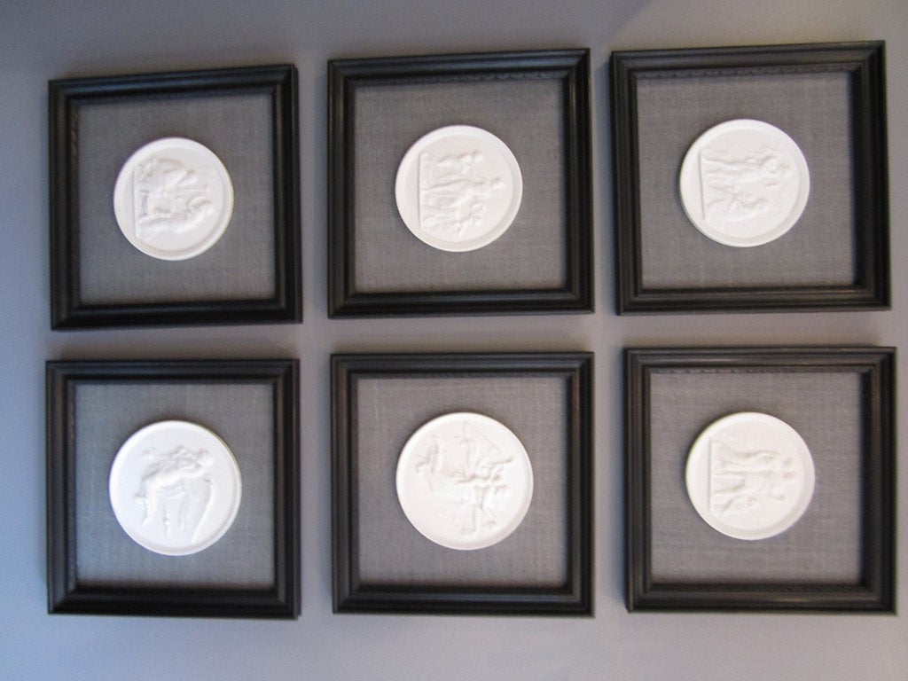 Set of six Royal Copenhagen porcelain bisque plaques on a gray raw silk and framed in black painted wood