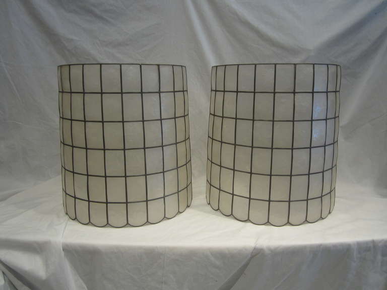 Pair of metal framed Capiz shell barrel-shaped lampshades with a scalloped bottom edge.