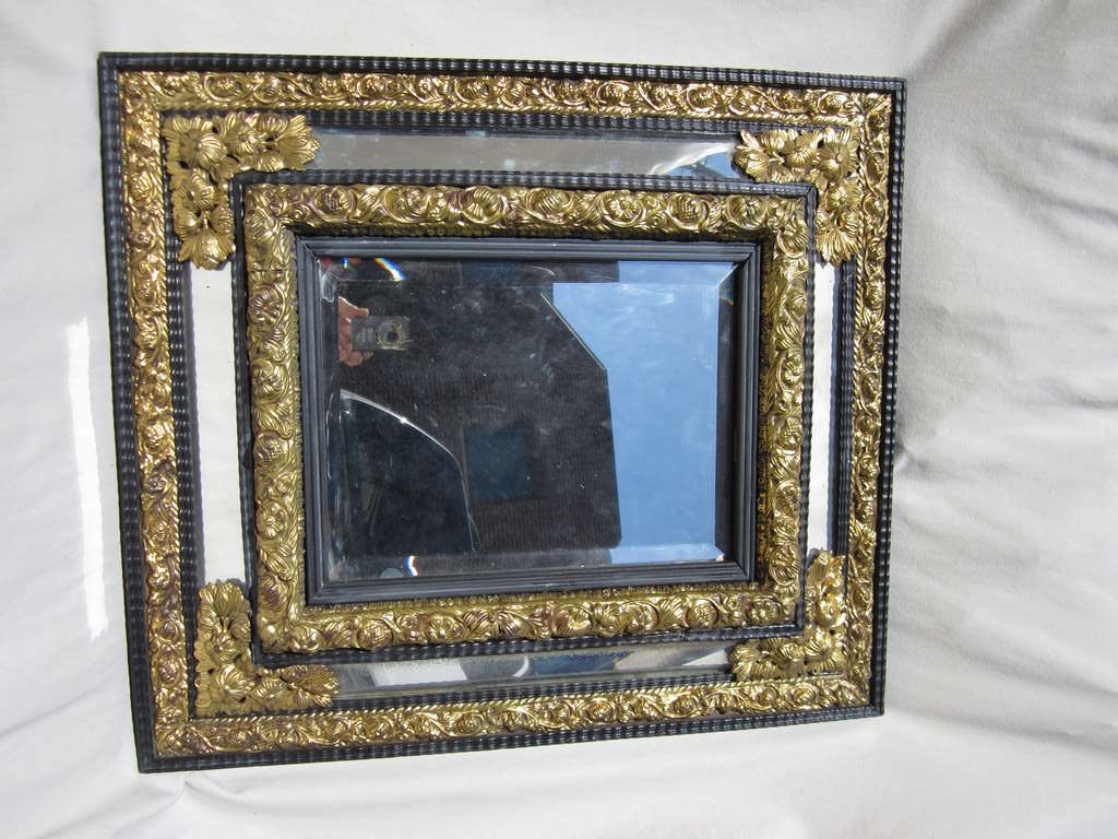 Dutch ebonized mirror with gilt metal embellishments.