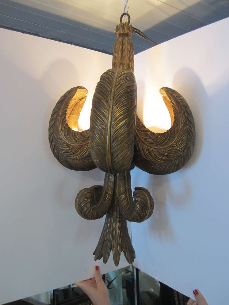 Rare and fabulous giltwood composite light fixture in the shape of feathers with four up lights and one down light.