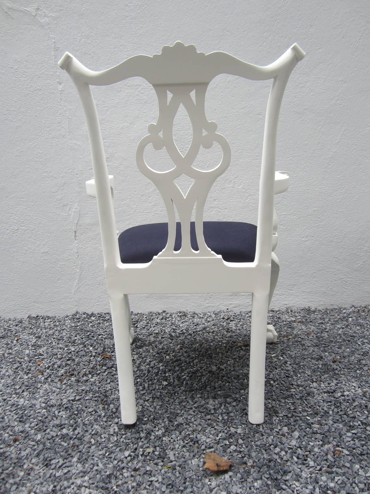 Elegant chalk or plaster white finished arm chair with claw and ball feet newly upholstered in navy linen.