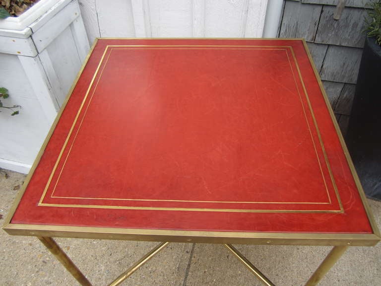 Very stylish Maison Jansen card/game table with red leather and gold tooled top on a fabulous brass base......a real show stopper.....