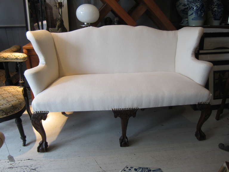 Handsome Chippendale style settee/bench newly upholstered in cream Belgian linen with bold claw and ball legs.....great hall or entry piece....it is also dining height