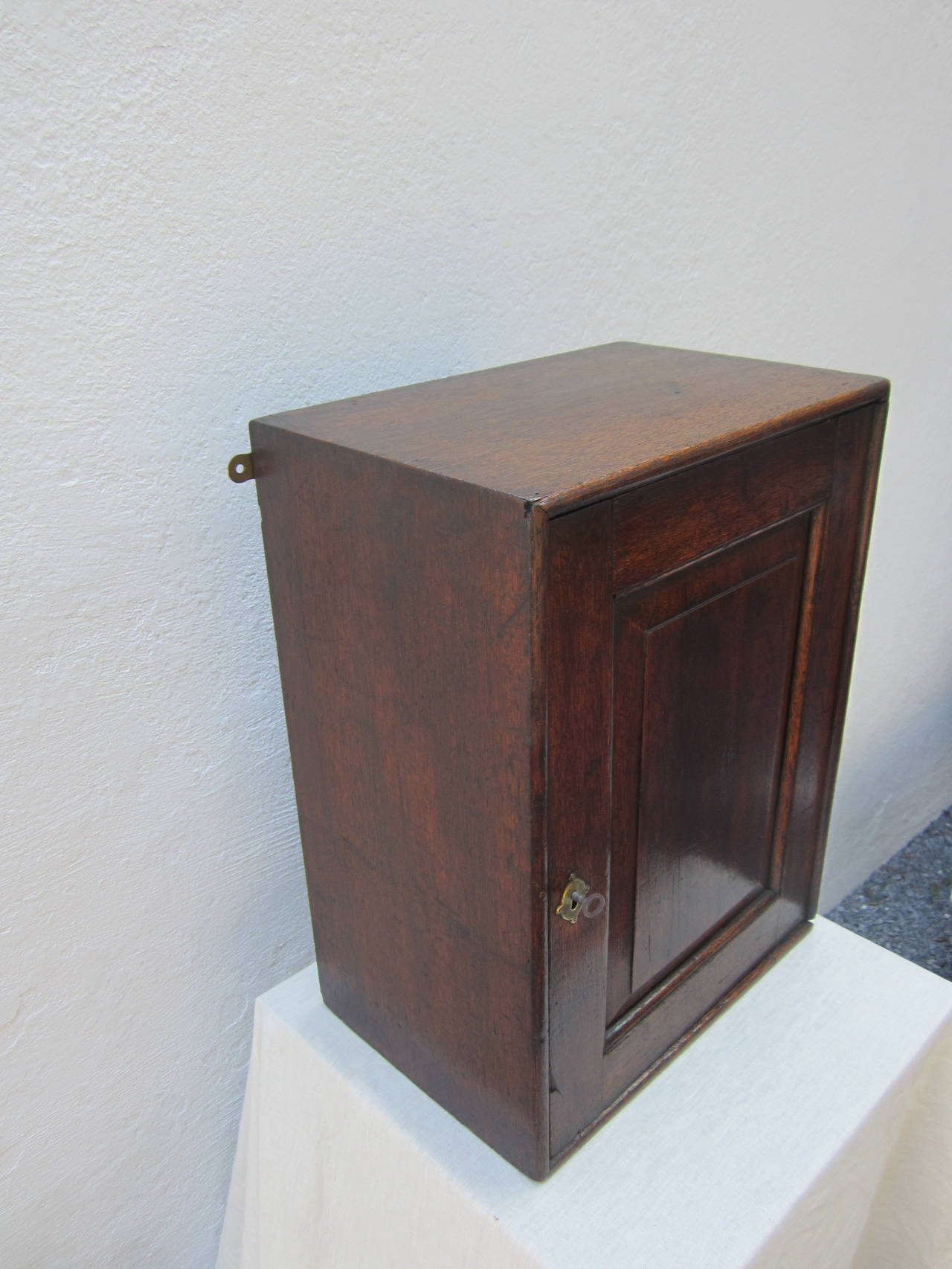 Wonderful antique walnut wall safe or cabinet with four interior drawers and lock with key.