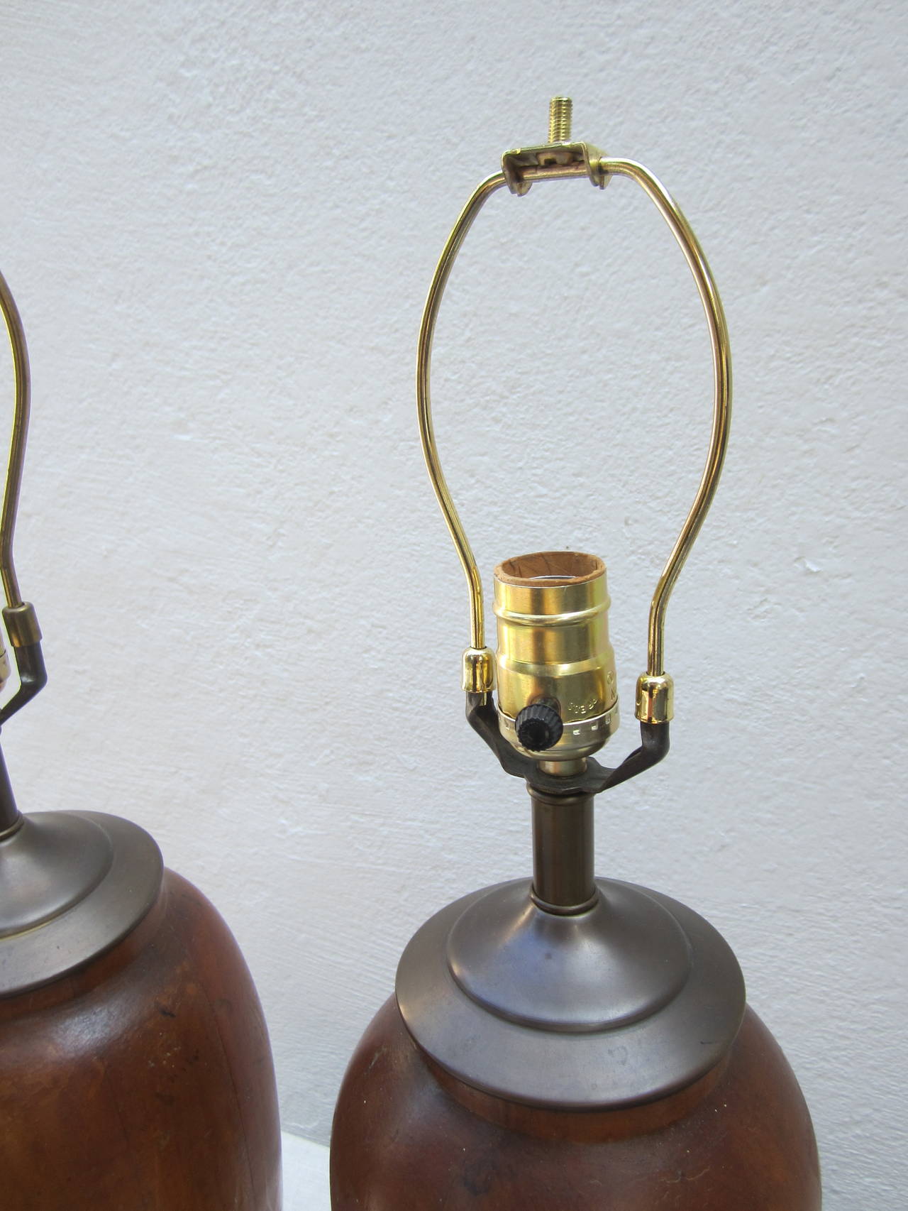 Handsome pair of wood table lamps with brass fittings.